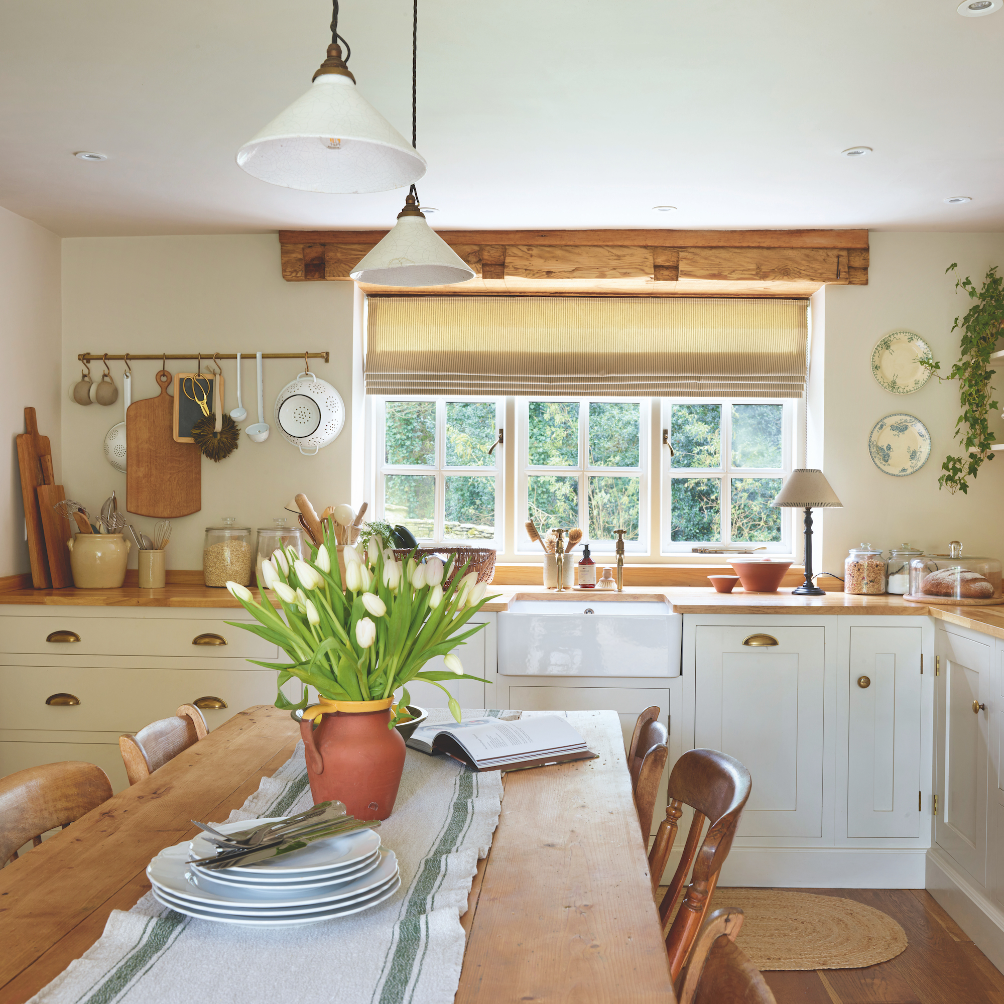 Yorkshire cottage kitchen with cream shaker style cabinets and a large farmhouse table and belfast sink